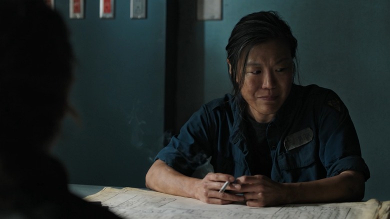 Sergeant Elise Park smoking a cigarette, looking stressed