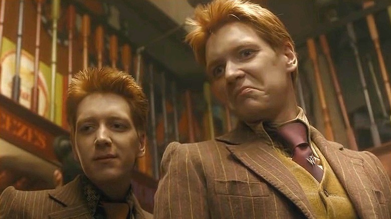 Fred and George in their prank shop, making faces