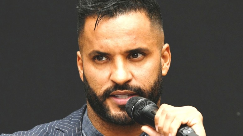 Ricky Whittle holding microphone