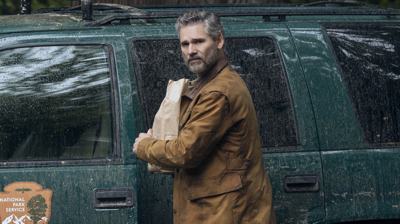 Kyle Turner next to muddy truck in Untamed