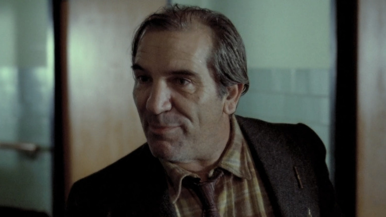 Titos Vandis leans in