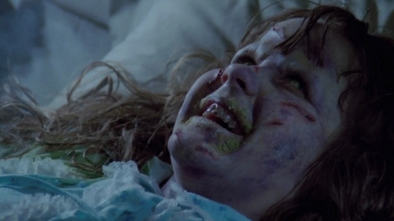 Possessed Regan smiling demonically