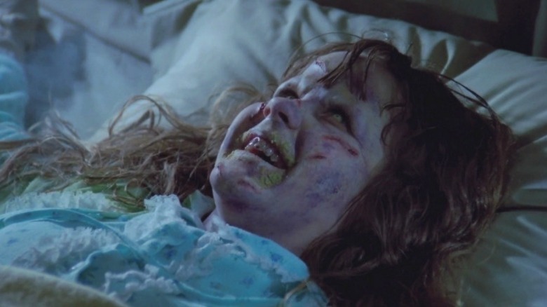 Possessed Regan smiling demonically