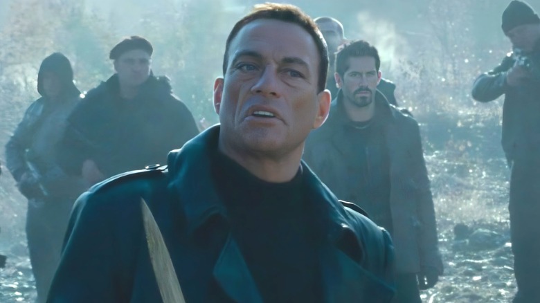 Vilain stands in front of soldiers