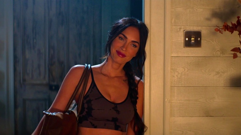 Gina leaning against the doorway in Expend4bles