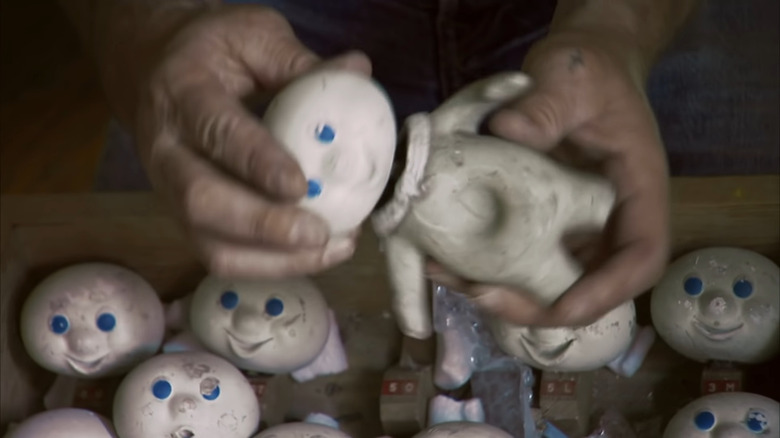 Holding a Pillsbury Doughboy model