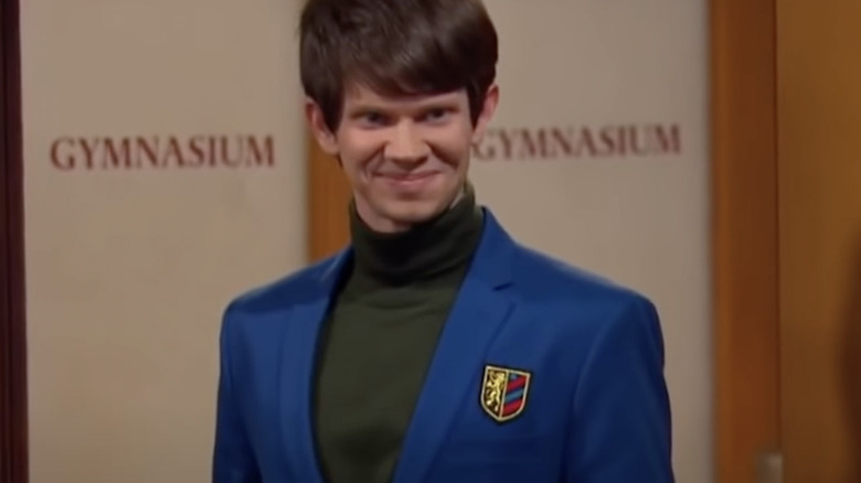 Lee Norris as Minkus wearing a blue suit with green turtleneck sweater in Girl meets World