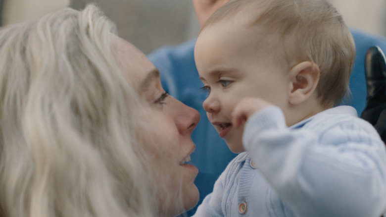 Sue Storm holding Franklin Richards in The Fantastic Four: First Steps