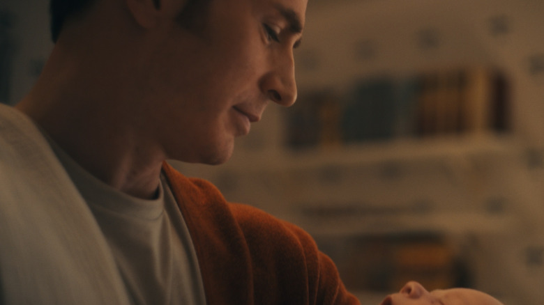 Steve Rogers smiling down at a baby in Avengers: Doomsday