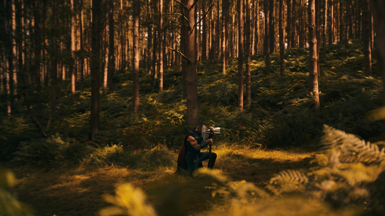 Thor kneeling in a forest with Stormbreaker in Avengers: Doomsday