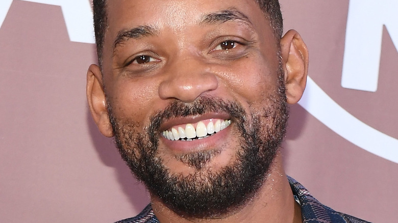 Will Smith grins at a premiere