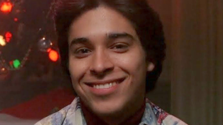 Fez smiling in front of Christmas lights