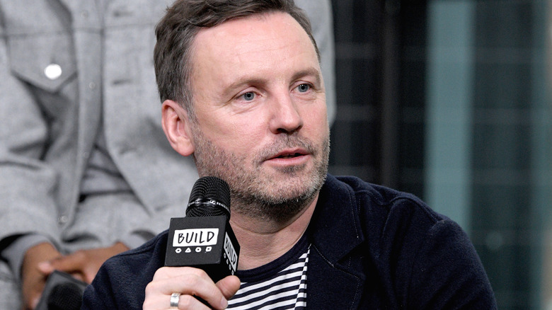 Brian Kirk holding a microphone