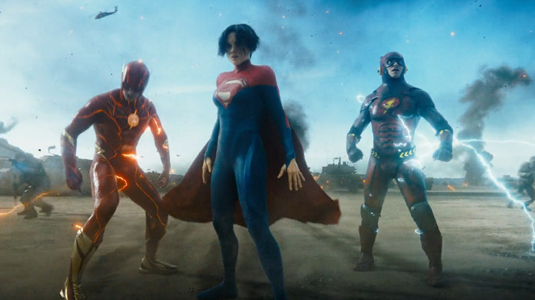 Flash, Flash, and Supergirl standing together