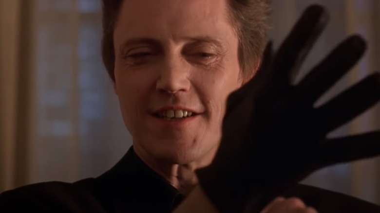 Frank smiling at glove in "King of New York" (1990)