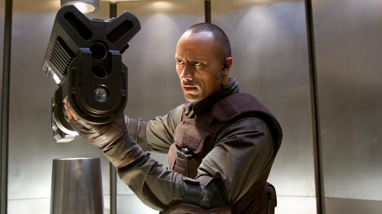 Dwayne Johnson holding gun
