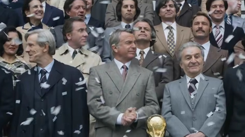 Sepp Blatter and João Havelange standing in a crowd of spectators in United Passions