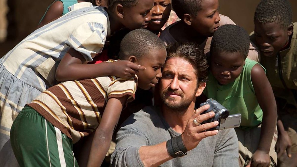Gerard Butler holding camcorder