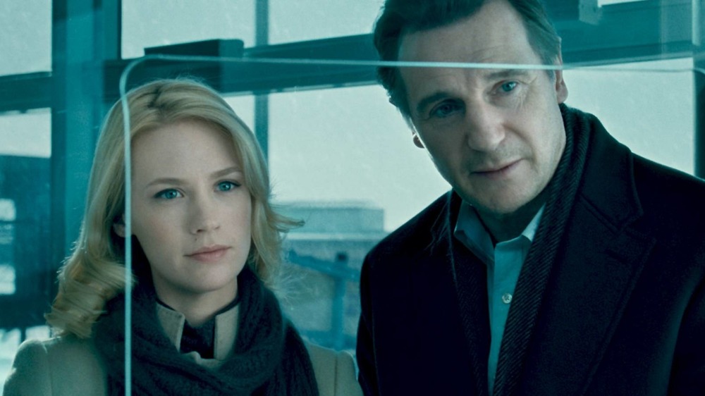 Liam Neeson and Diane Kruger look across a ticket counter