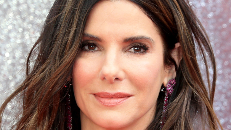 Sandra Bullock wearing purple earrings