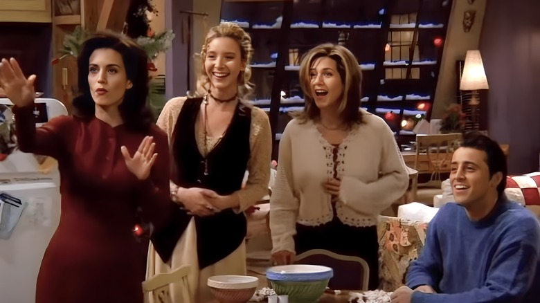 Monica, Phoebe, Rachel and Joey smiling