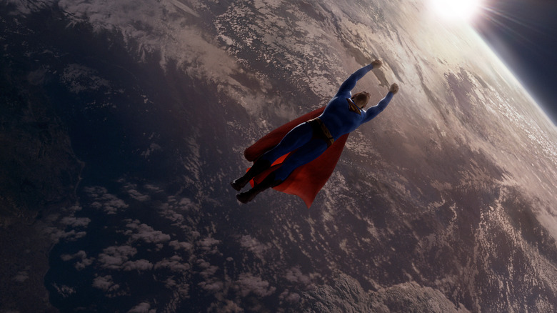 Superman soaring above the Earth