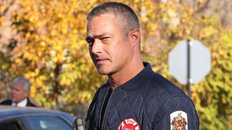 Kelly Severide stands in front of a vehicle on 