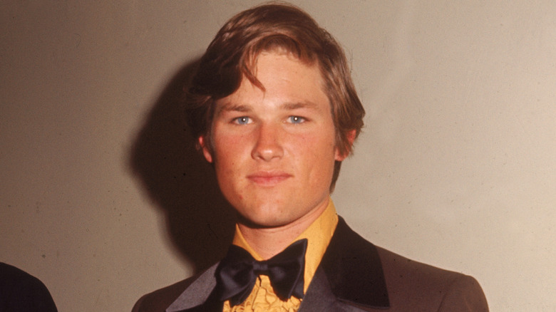 Young Kurt Russell in tuxedo with gold ruffled shirt