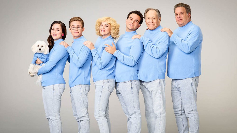 The cast of The Goldbergs posing for an awkward family photo