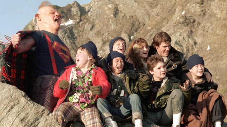 Sloth, Chunk, Stef, Data, Andy, Mouth, Brand, and Mikey sitting outside on rocks