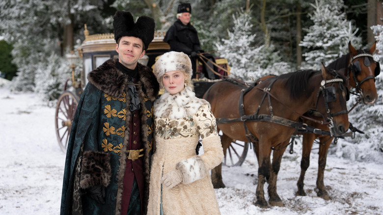 Peter and Catherine standing in front of carriage in snow