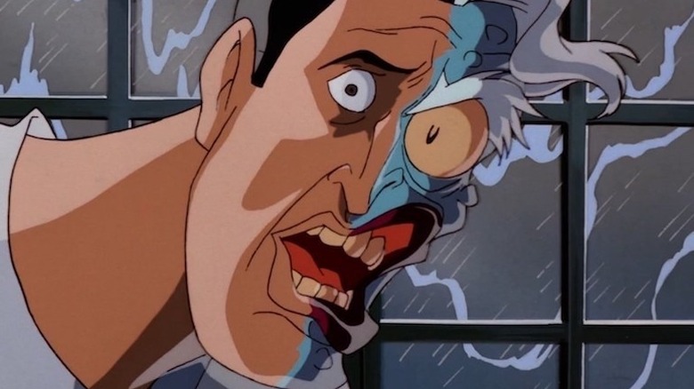 Two-Face standing in front of a window while it's raining outside