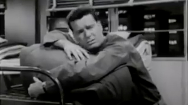 James Garner sleeps on cot