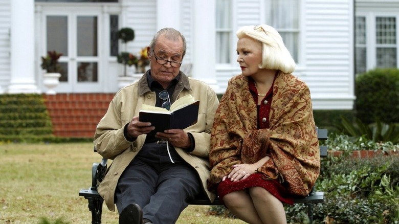 James Garner reads on a bench