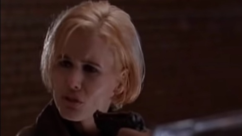 Samantha and a man point guns at each other