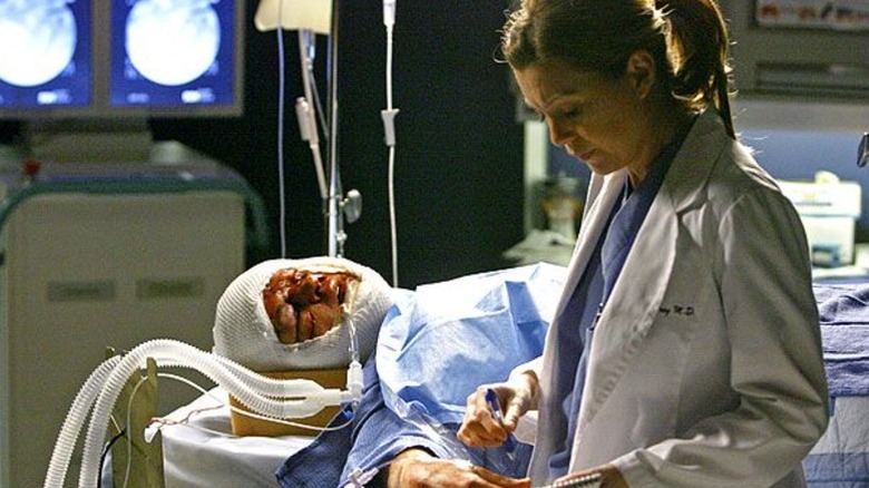 George on the operating table with Meredith next to him