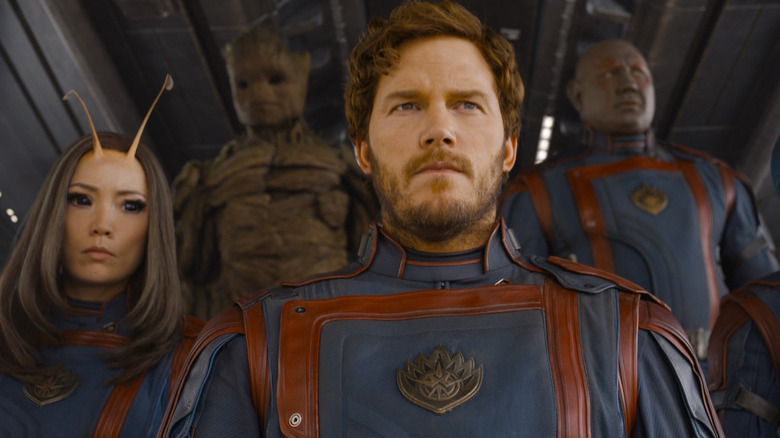 Peter Quill holding Zune Gamora standing