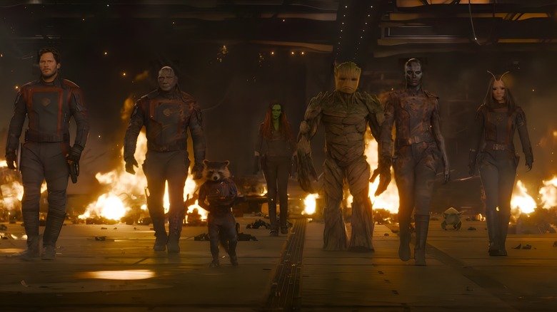 Peter Quill, Drax, Rocket, Gamora, Groot, Nebula, and Mantis walking in front of flames
