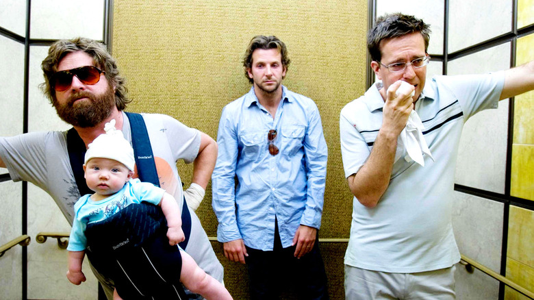 Phil, Stu, and Alan carry a baby in an elevator in "The Hangover" (2009)