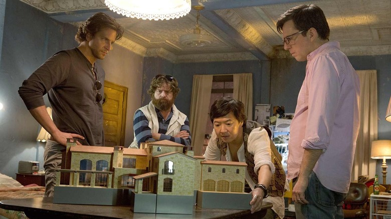 Leslie shows Phil, Stu, and Alan a model in "The Hangover Part III" (2013)