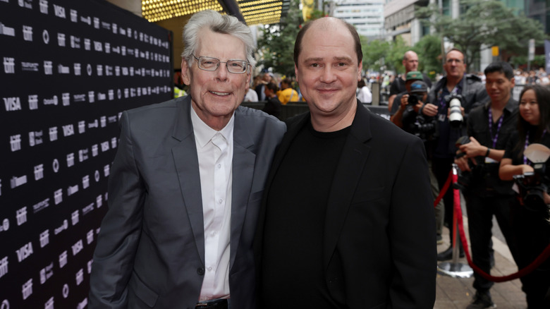 Mike Flanagan and Stephen King standing on a red carpet