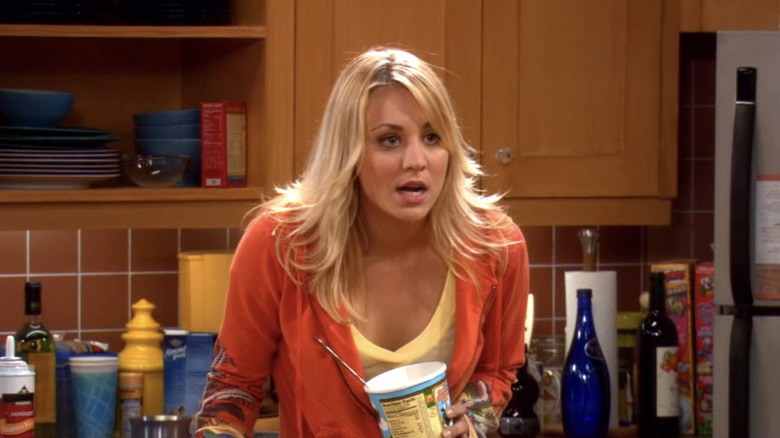 Penny yelling at someone while holding a container of ice cream in 