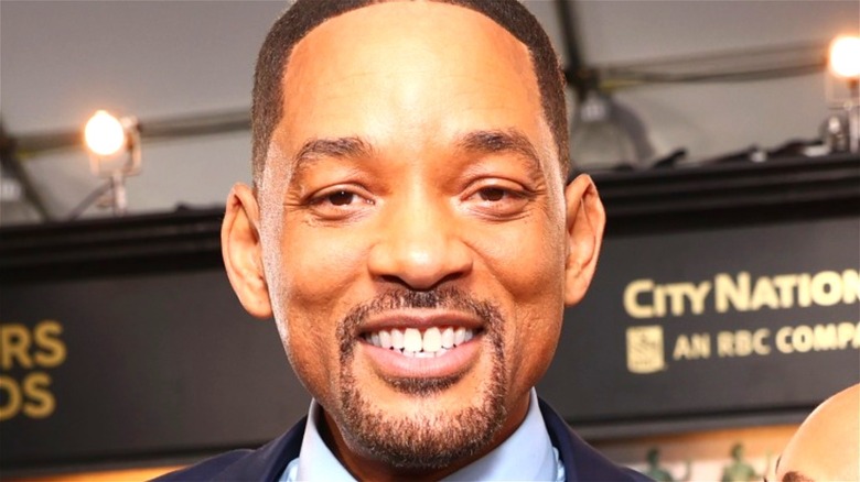Will Smith smiling at a red-carpet event 