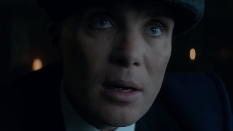 Tommy Shelby wearing a hat and jacket