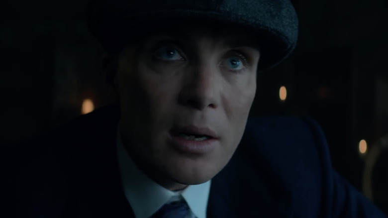 Tommy Shelby wearing a hat and jacket