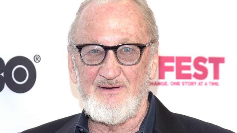 Robert Englund smiles at an event