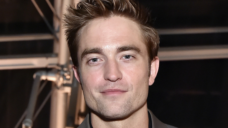 Robert Pattinson smirking at an event