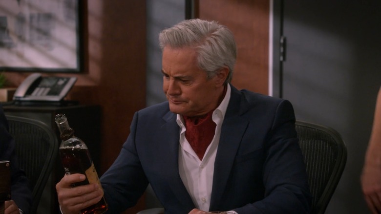 The Captain looking at bottle