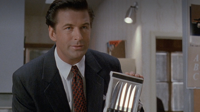 Alec Baldwin holds knives