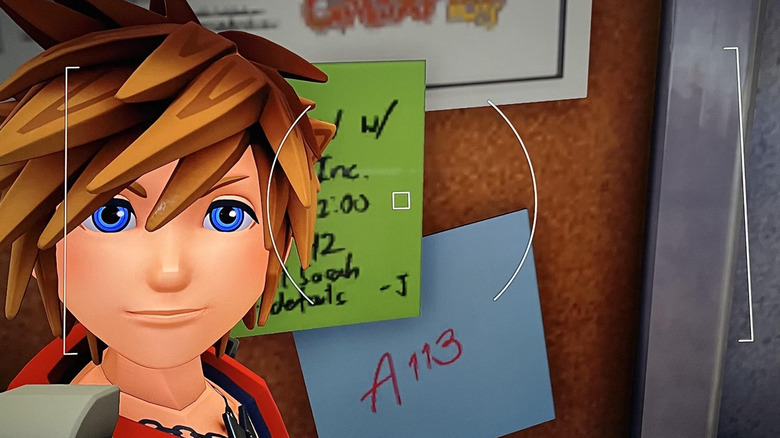 Sora selfie in front of bulletin board